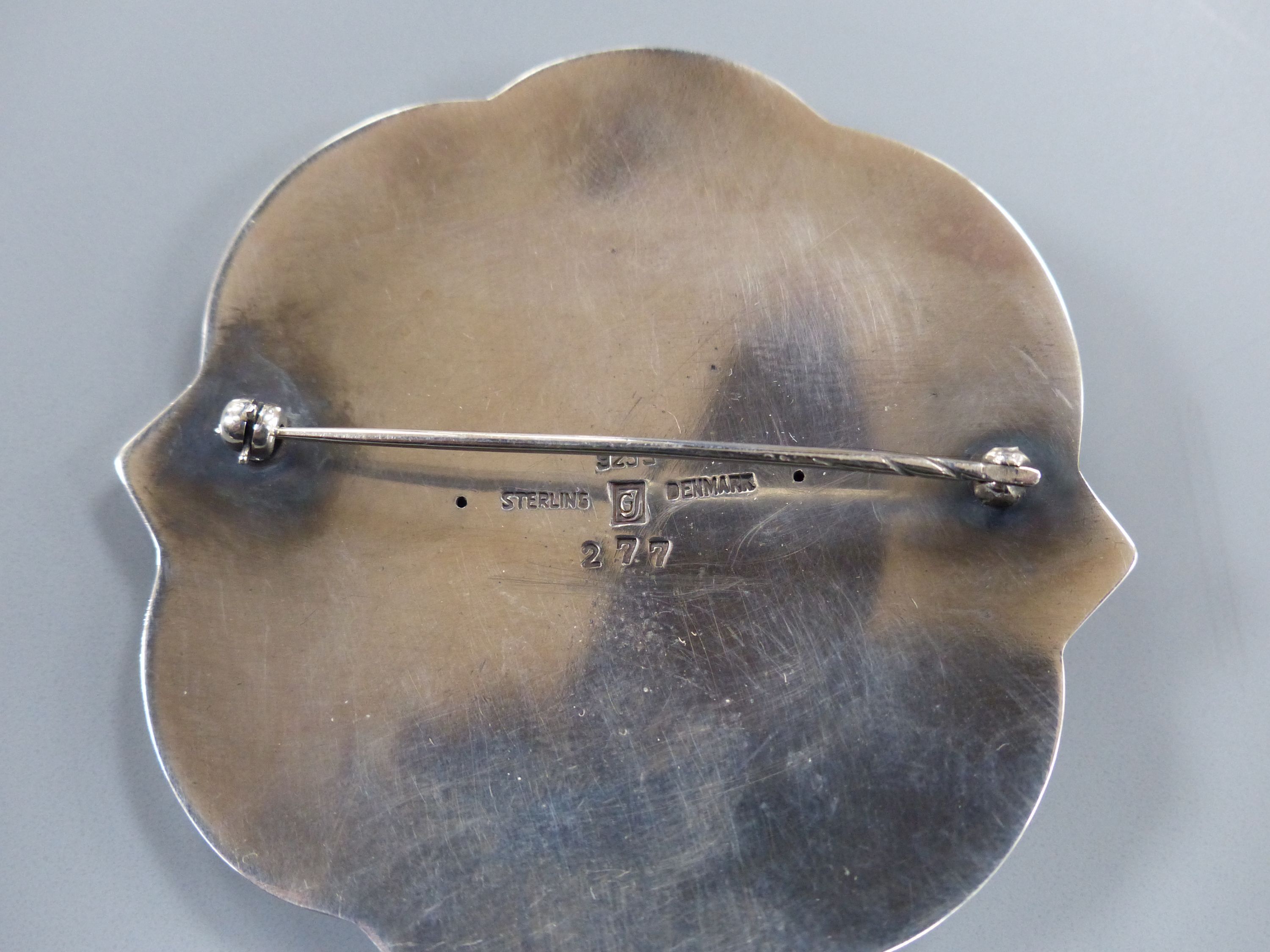 A George Jensen sterling shaped circular brooch, design no. 277 (Arno Malinowski?) depicting a mermaid on sea horse, 57mm.